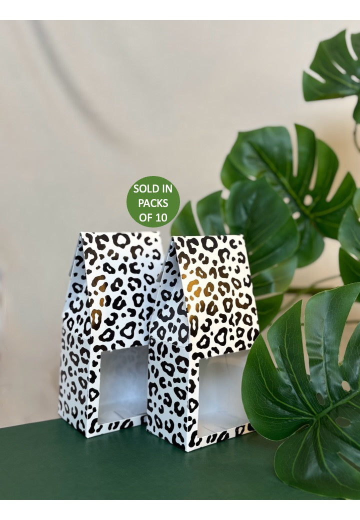 Leopard print boxes with a plant in the background