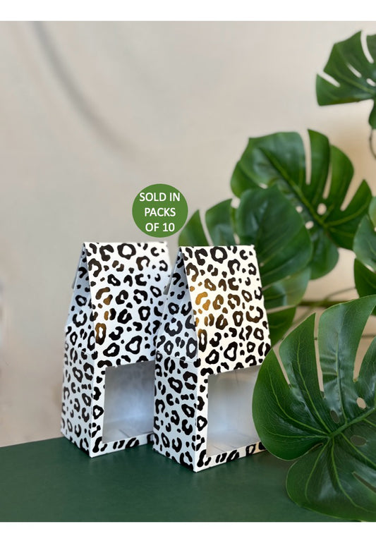 Leopard print boxes with a plant in the background