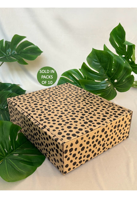 Leopard print box with green leaves on a light background