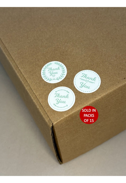 Kraft paper box with 'Thank You' stickers and a red label indicating packs of 15.