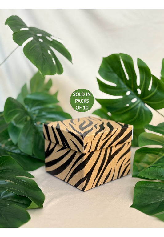 Zebra-striped box with green leaves in the background