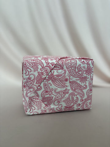 Pink paisley-patterned box on a light gray background