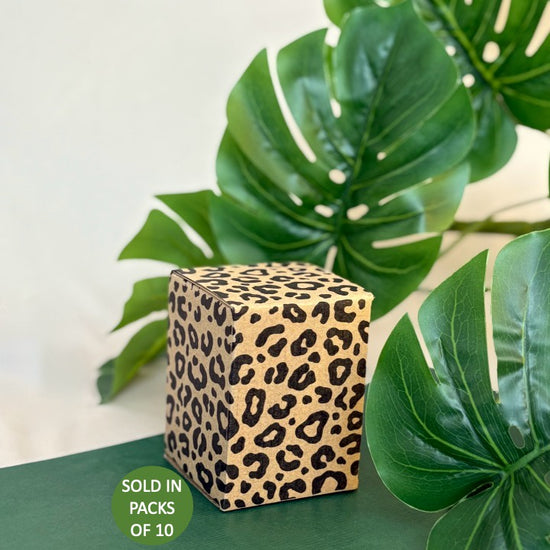 Leopard print cube with green leaves in the background