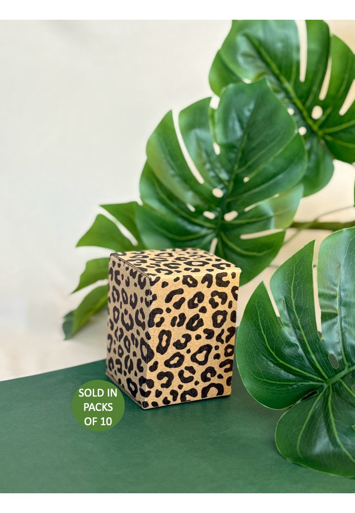 Leopard print cube with green leaves in the background