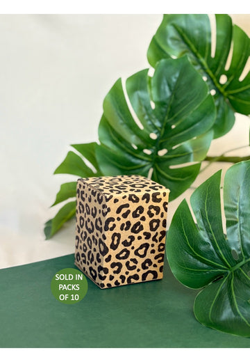 Leopard print cube with green leaves in the background