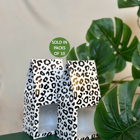 Leopard print boxes with a plant in the background
