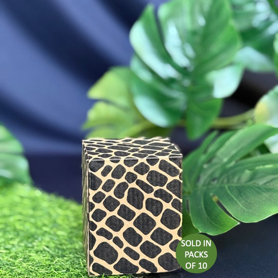 Black and gold textured box on a blue background with green leaves