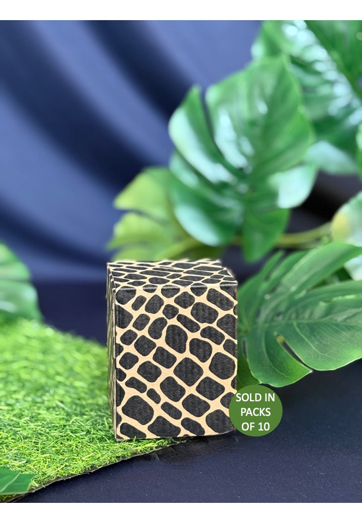 Black and gold textured box on a blue background with green leaves