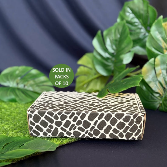 Patterned box with green leaves on a dark background