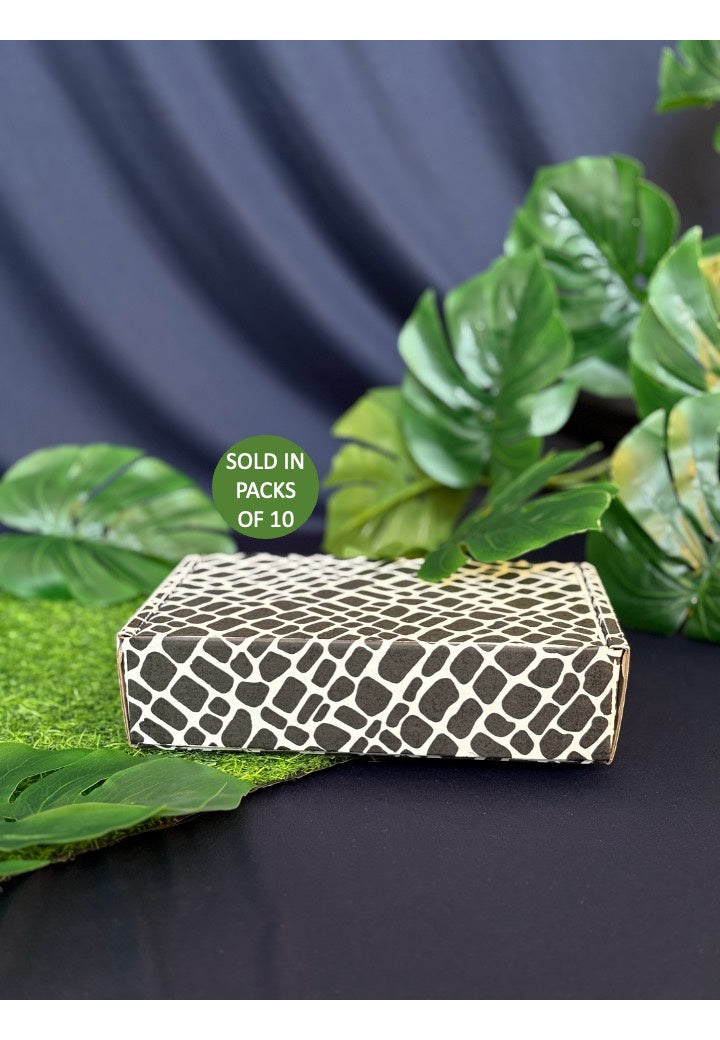 Patterned box with green leaves on a dark background