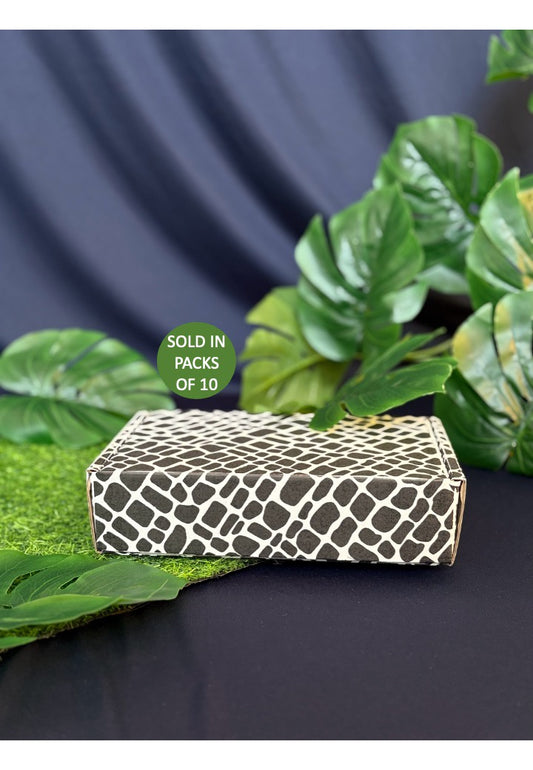 Patterned box with green leaves on a dark background