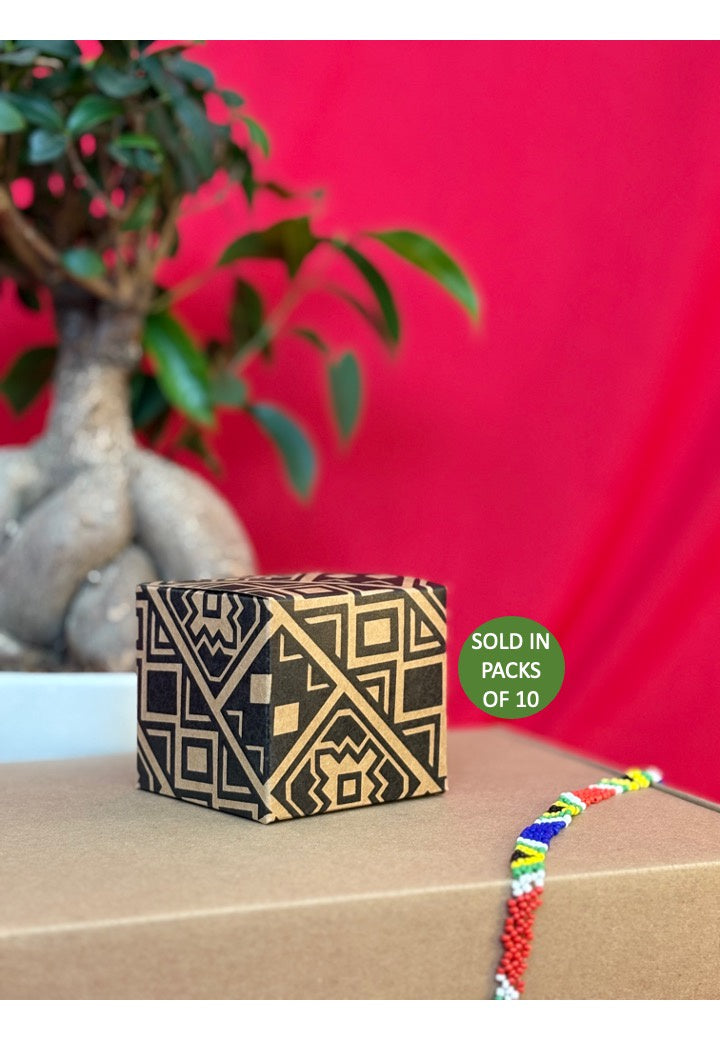 Decorative box with geometric pattern on a wooden surface with a red background