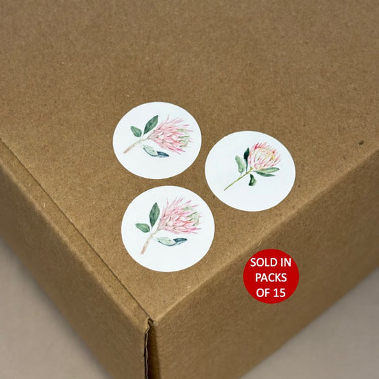 Floral stickers on a cardboard box with a 'sold in packs of 15' label.