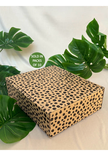 Leopard print box with green leaves on a light background