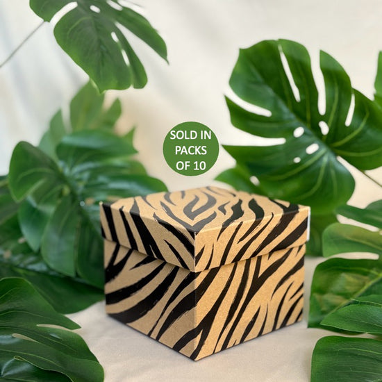 Zebra-striped box with green leaves in the background